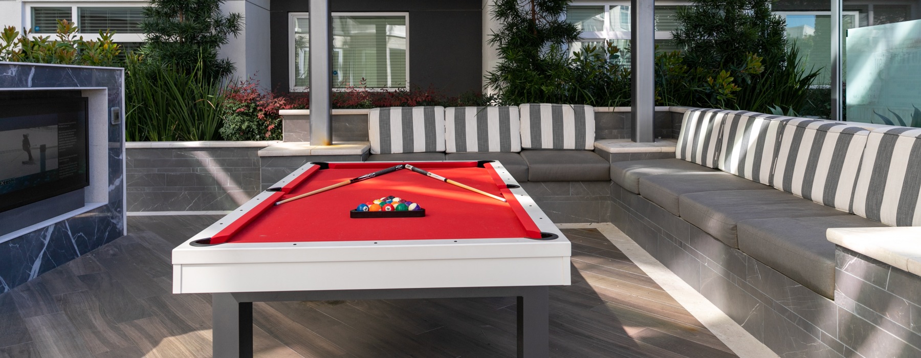 pool table with seating around it